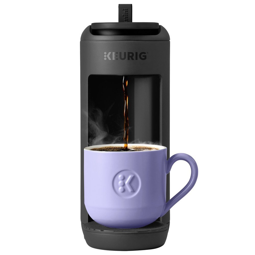 Keurig K-Mini Mate coffee maker in matte black brewing into a lavender mug